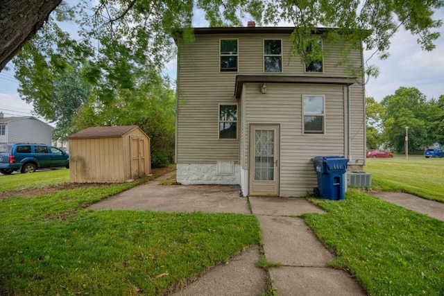 3026 5th Ave E, Hibbing, MN 55746 - back of property featuring a shed, a lawn, a patio area, and a chimney