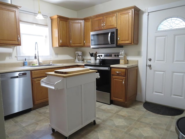 703 1st St SW, Wadena, MN 56482 - kitchen featuring stainless steel appliances, plenty of natural light, and light countertops