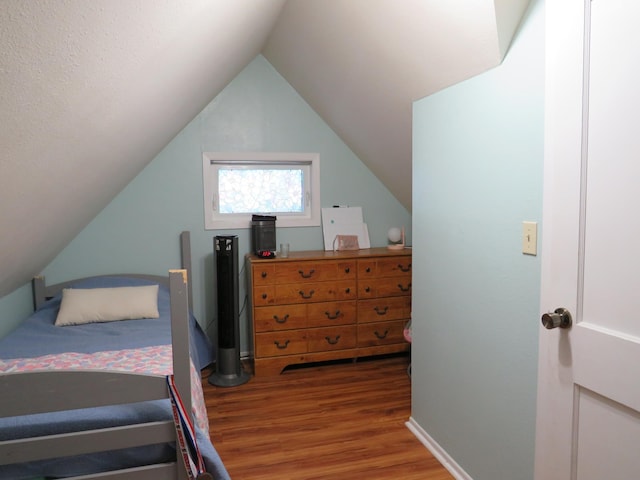 703 1st St SW, Wadena, MN 56482 - bedroom with wood finished floors and vaulted ceiling