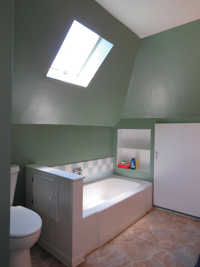 703 1st St SW, Wadena, MN 56482 - bathroom with a skylight, a garden tub, and lofted ceiling