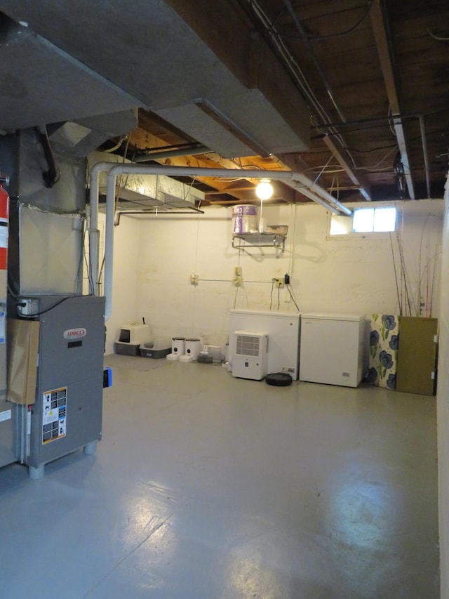 703 1st St SW, Wadena, MN 56482 - below grade area featuring fridge and heating unit