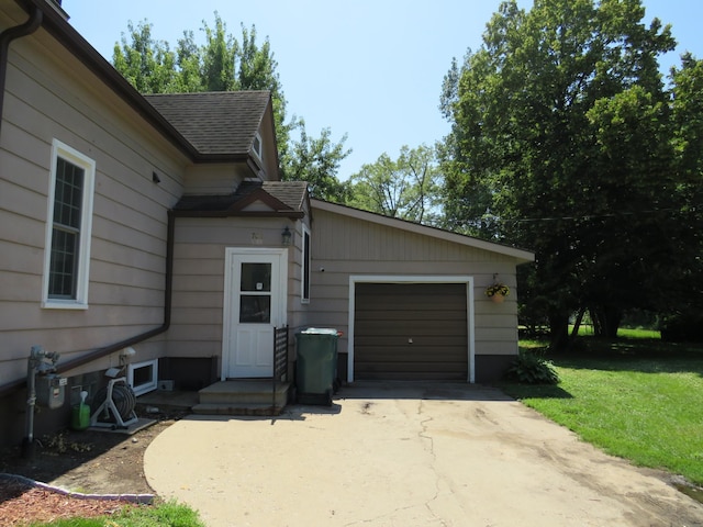703 1st St SW, Wadena, MN 56482 - view of home's exterior with driveway, roof with shingles, a yard, and a garage