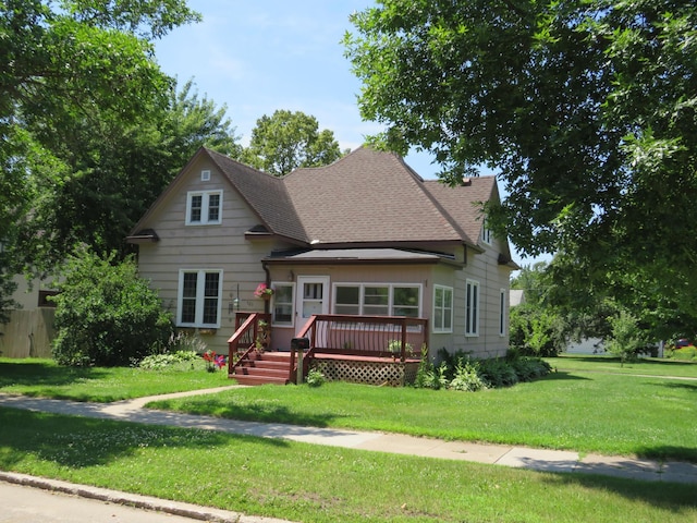 703 1st St SW, Wadena, MN 56482 - view of front of property with a wooden deck, a front yard, and roof with shingles