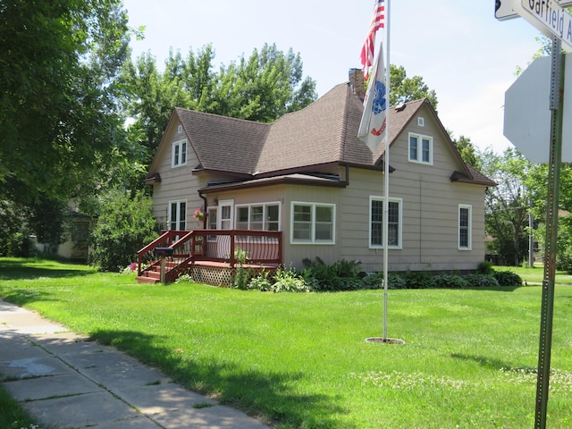 703 1st St SW, Wadena, MN 56482 - back of house with roof with shingles, a wooden deck, and a lawn
