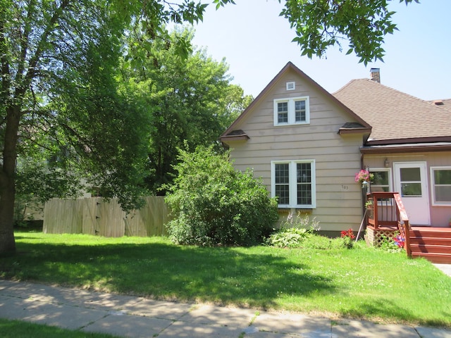 703 1st St SW, Wadena, MN 56482 - rear view of house featuring a shingled roof and a chimney