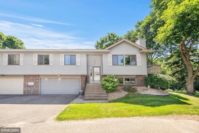 911 Lawnview Ave, Shoreview, MN 55126 - bi-level home with brick siding, asphalt driveway, an attached garage, a front yard, and a chimney