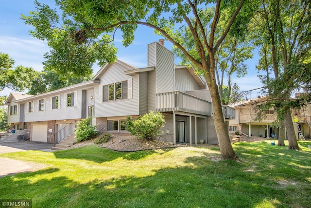 911 Lawnview Ave, Shoreview, MN 55126 - split foyer home with a chimney, an attached garage, asphalt driveway, brick siding, and a front lawn