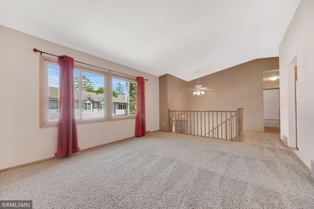 911 Lawnview Ave, Shoreview, MN 55126 - spare room with vaulted ceiling, carpet floors, and a ceiling fan