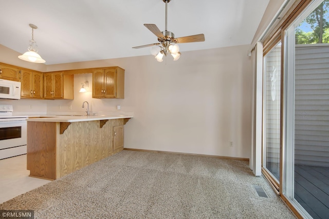 911 Lawnview Ave, Shoreview, MN 55126 - kitchen featuring white appliances, light countertops, a ceiling fan, a breakfast bar area, and pendant lighting
