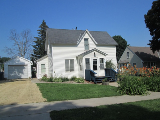 526 Red Wing Ave, Kenyon, MN 55946 - view of front of property with an outbuilding, concrete driveway, a garage, a front yard, and roof with shingles