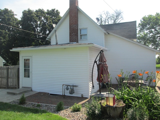 526 Red Wing Ave, Kenyon, MN 55946 - view of side of property with a chimney and roof with shingles