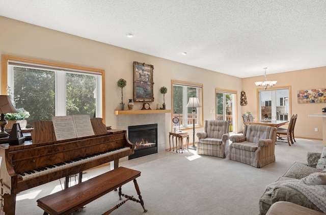 10931 185th Cir NW, Elk River, MN 55330 - living room with a chandelier, light carpet, a fireplace, and a textured ceiling