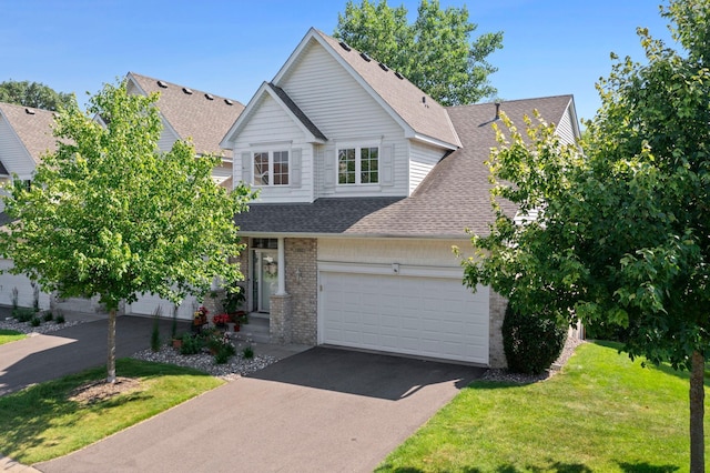 10931 185th Cir NW, Elk River, MN 55330 - traditional-style house featuring a shingled roof, asphalt driveway, brick siding, and a front yard