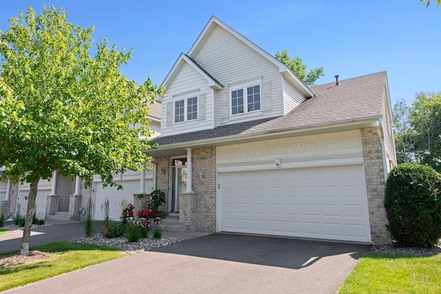 10931 185th Cir NW, Elk River, MN 55330 - traditional home with roof with shingles, driveway, and brick siding