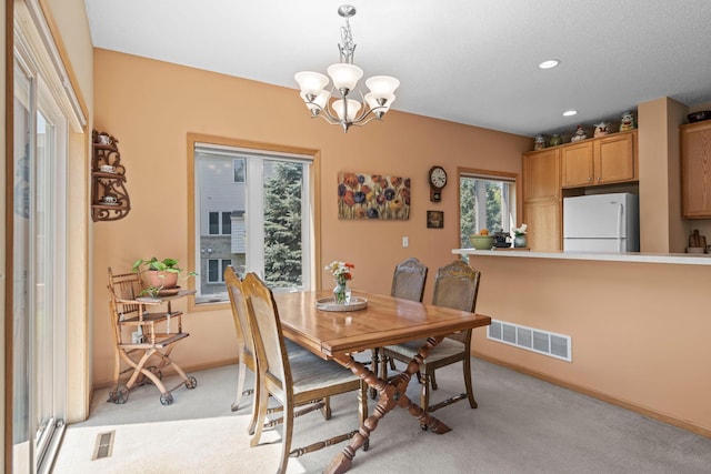 10931 185th Cir NW, Elk River, MN 55330 - dining area featuring healthy amount of natural light, light colored carpet, a chandelier, and recessed lighting