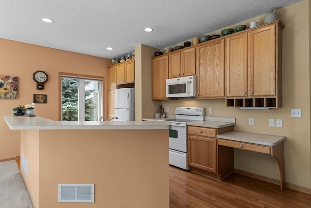 10931 185th Cir NW, Elk River, MN 55330 - kitchen with white appliances, light wood-type flooring, light countertops, recessed lighting, and a textured ceiling