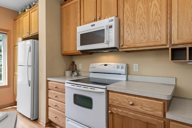 10931 185th Cir NW, Elk River, MN 55330 - kitchen with white appliances, light countertops, and light wood-style floors
