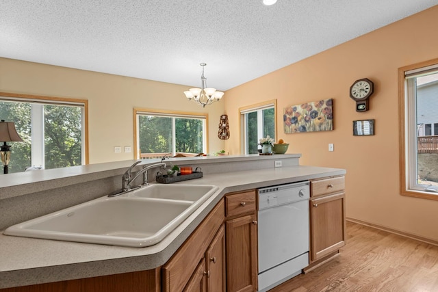 10931 185th Cir NW, Elk River, MN 55330 - kitchen with a chandelier, dishwasher, light wood-style flooring, decorative light fixtures, and brown cabinets