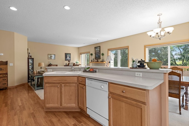 10931 185th Cir NW, Elk River, MN 55330 - kitchen featuring dishwasher, light countertops, a textured ceiling, light wood finished floors, and a chandelier