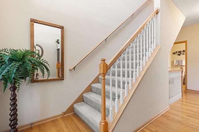 10931 185th Cir NW, Elk River, MN 55330 - staircase featuring wood finished floors and baseboards