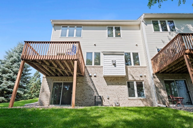 10931 185th Cir NW, Elk River, MN 55330 - back of property with brick siding, a yard, and a wooden deck
