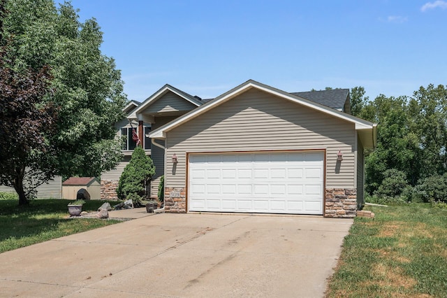 509 2nd St S, Montrose, MN 55363 - view of front of home with stone siding, driveway, and an attached garage