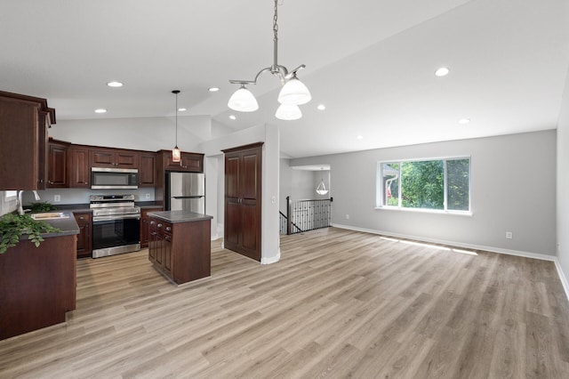 509 2nd St S, Montrose, MN 55363 - kitchen with stainless steel appliances, lofted ceiling, dark countertops, a center island, and open floor plan