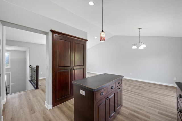509 2nd St S, Montrose, MN 55363 - kitchen with dark countertops, vaulted ceiling, light wood-style floors, pendant lighting, and a chandelier