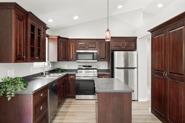 509 2nd St S, Montrose, MN 55363 - kitchen featuring appliances with stainless steel finishes, vaulted ceiling, light wood-style floors, a center island, and glass insert cabinets