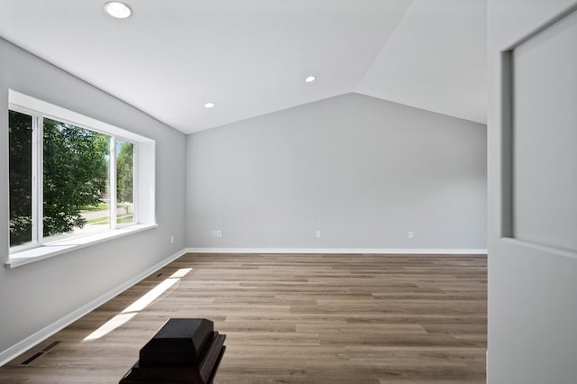 509 2nd St S, Montrose, MN 55363 - unfurnished room with recessed lighting, vaulted ceiling, and wood finished floors