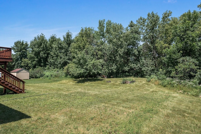509 2nd St S, Montrose, MN 55363 - view of green lawn with stairs, a wooden deck, and an outbuilding