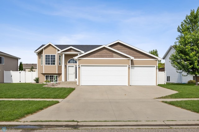 4416 10th St W, Fargo, ND 58078 - view of front of house with concrete driveway, an attached garage, and a gate