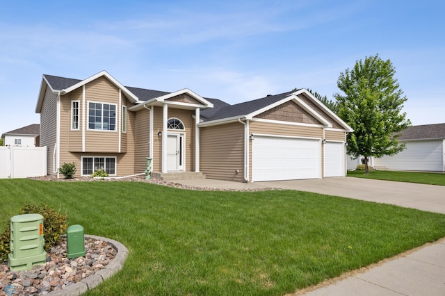 4416 10th St W, Fargo, ND 58078 - view of front facade with concrete driveway, a garage, and a shingled roof