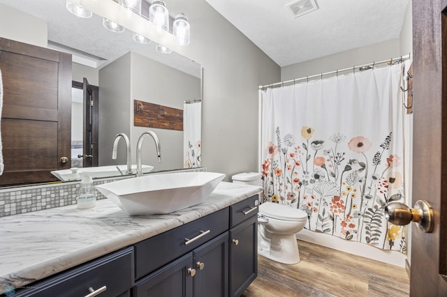 4416 10th St W, Fargo, ND 58078 - bathroom featuring wood finished floors, vanity, and a shower with curtain