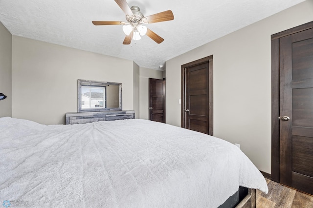4416 10th St W, Fargo, ND 58078 - bedroom with wood finished floors, a textured ceiling, and a ceiling fan