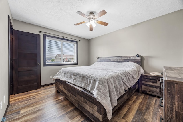 4416 10th St W, Fargo, ND 58078 - bedroom with dark wood-type flooring, a textured ceiling, and a ceiling fan