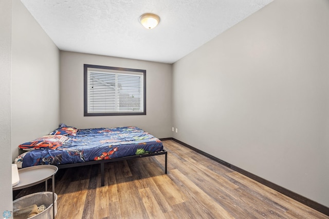 4416 10th St W, Fargo, ND 58078 - bedroom with wood finished floors and a textured ceiling
