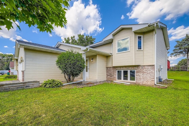 2208 84th Ave N, Brooklyn Park, MN 55444 - tri-level home featuring a front yard and brick siding