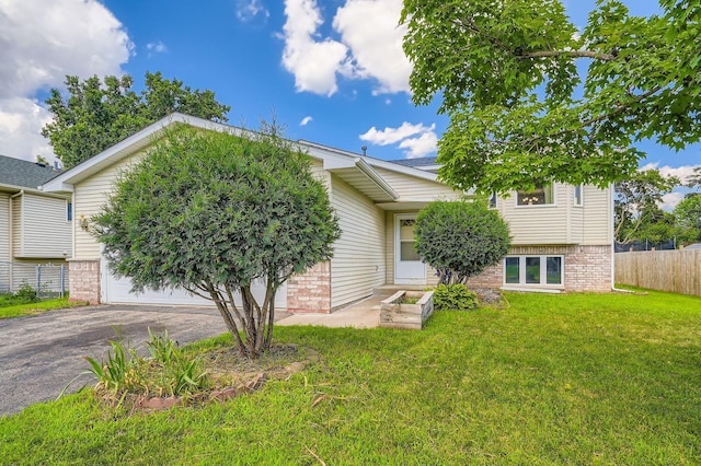 2208 84th Ave N, Brooklyn Park, MN 55444 - view of front facade with a garage, asphalt driveway, and brick siding