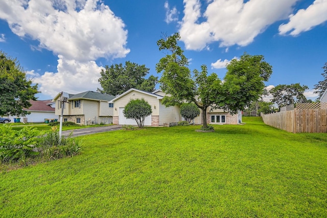 2208 84th Ave N, Brooklyn Park, MN 55444 - view of yard featuring driveway and a garage