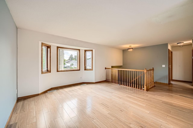 2208 84th Ave N, Brooklyn Park, MN 55444 - spare room featuring baseboards and light wood finished floors