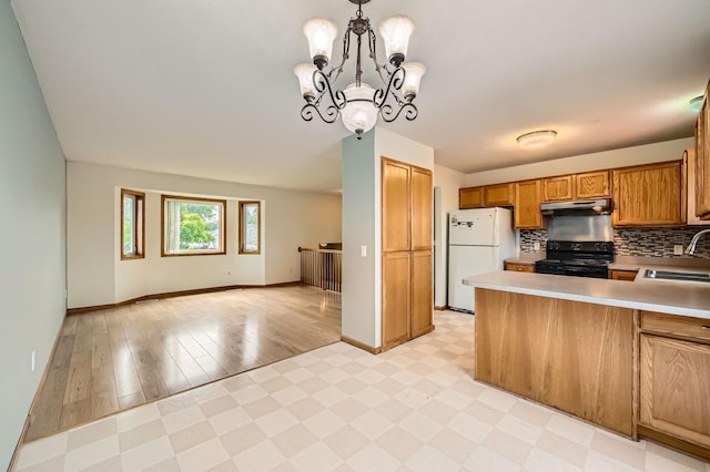 2208 84th Ave N, Brooklyn Park, MN 55444 - kitchen with black / electric stove, freestanding refrigerator, a peninsula, brown cabinetry, and light countertops