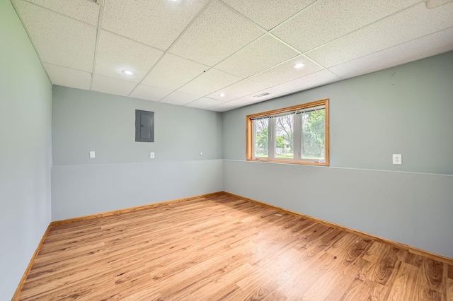2208 84th Ave N, Brooklyn Park, MN 55444 - unfurnished room with wood finished floors, a paneled ceiling, electric panel, and recessed lighting