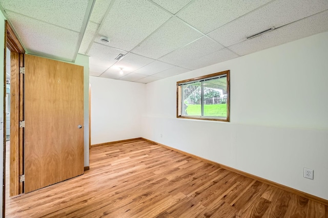 2208 84th Ave N, Brooklyn Park, MN 55444 - unfurnished bedroom featuring a drop ceiling and wood finished floors