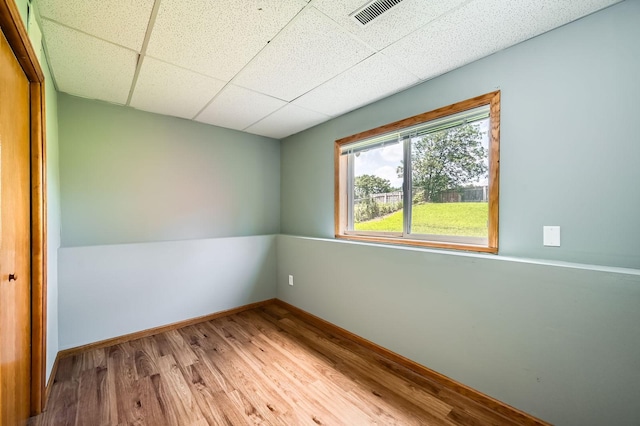 2208 84th Ave N, Brooklyn Park, MN 55444 - spare room with wood finished floors and a paneled ceiling