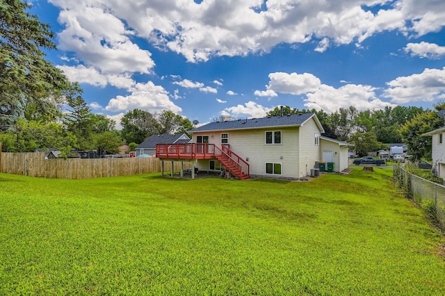 2208 84th Ave N, Brooklyn Park, MN 55444 - rear view of house featuring stairway, a deck, and a fenced backyard