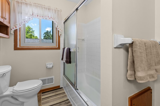 5833 Perry Ave N, Crystal, MN 55429 - bathroom featuring toilet and bath / shower combo with glass door