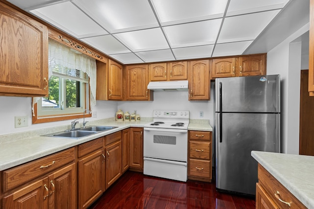5833 Perry Ave N, Crystal, MN 55429 - kitchen featuring freestanding refrigerator, white range with electric cooktop, under cabinet range hood, and brown cabinetry