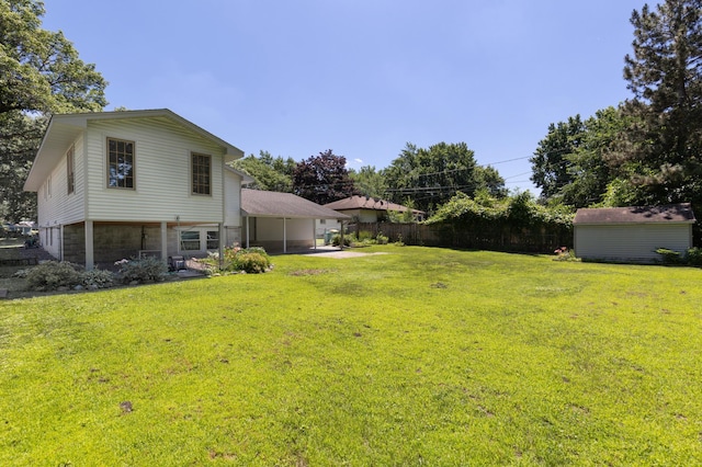5833 Perry Ave N, Crystal, MN 55429 - view of yard featuring a storage shed, a patio area, and an attached carport