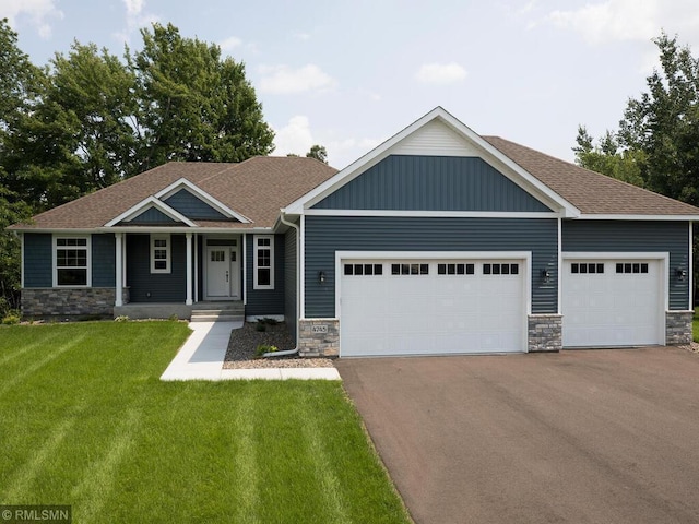 0000 Central Dr NE, Cambridge, MN 55008 - craftsman-style house featuring stone siding, a garage, driveway, a front yard, and a shingled roof